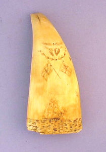 Antique scrimshaw sperm whale;s tooth with ships.