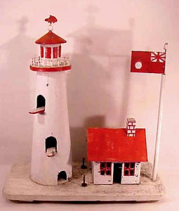 A lighthouse birdhouse in old paint.