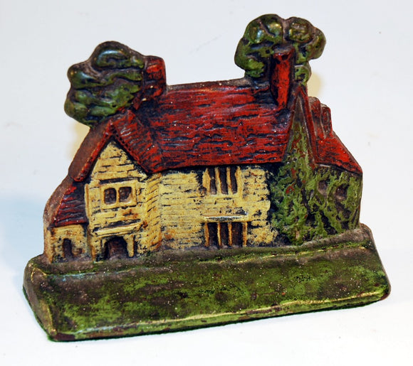 Antique American cast iron doorstop of a country cottage