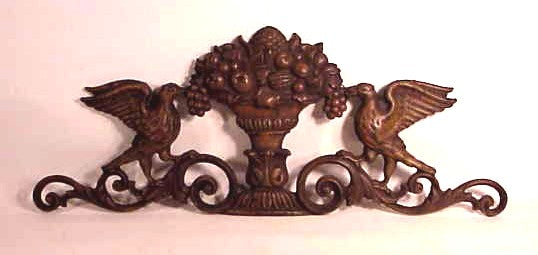 Antique cast-iron wall plaque with birds.