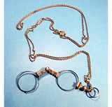 Antique gold folding eyeglasses on long chain.