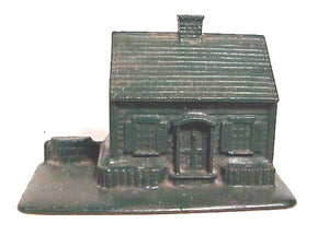 antique green painted cottage.