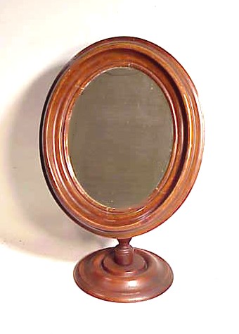 Antique oval toilet mirror on adjustable stand.