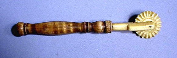 Antique scrimshaw pie crimper with wooden handle