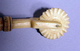 Antique scrimshaw pie crimper with wooden handle