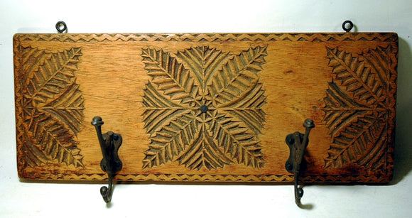 Antique wooden hat rack with chip carved design