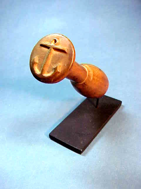 Carved wooden stamp with raised anchor
