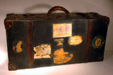 Charming antique suitcase with travel stickers.