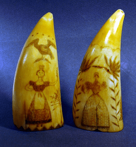 Pair of choice antique scrimshaw sperm whale's teeth